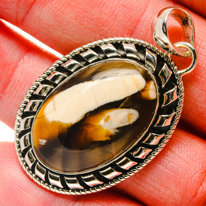 Oval jasper gemstone pendant with white and amber bands in detailed sterling silver frame