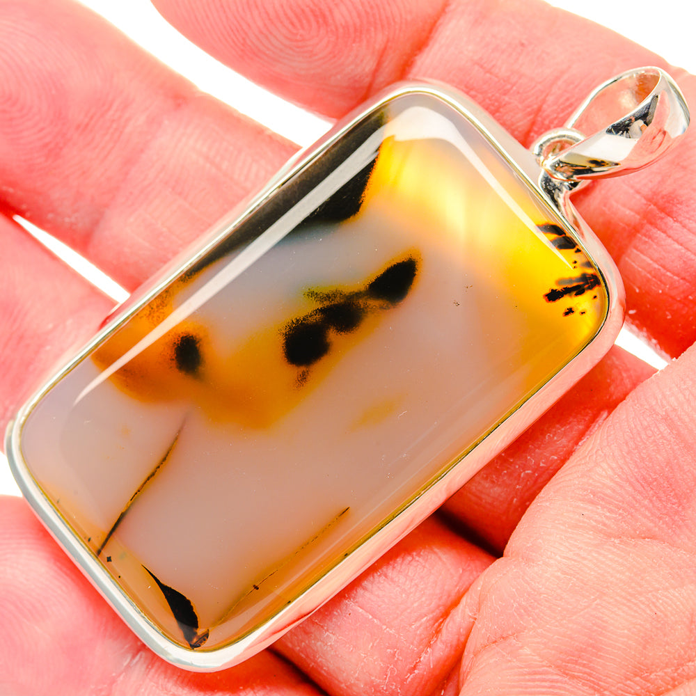 Montana agate pendant in sterling silver bezel, amber and black mottled stone