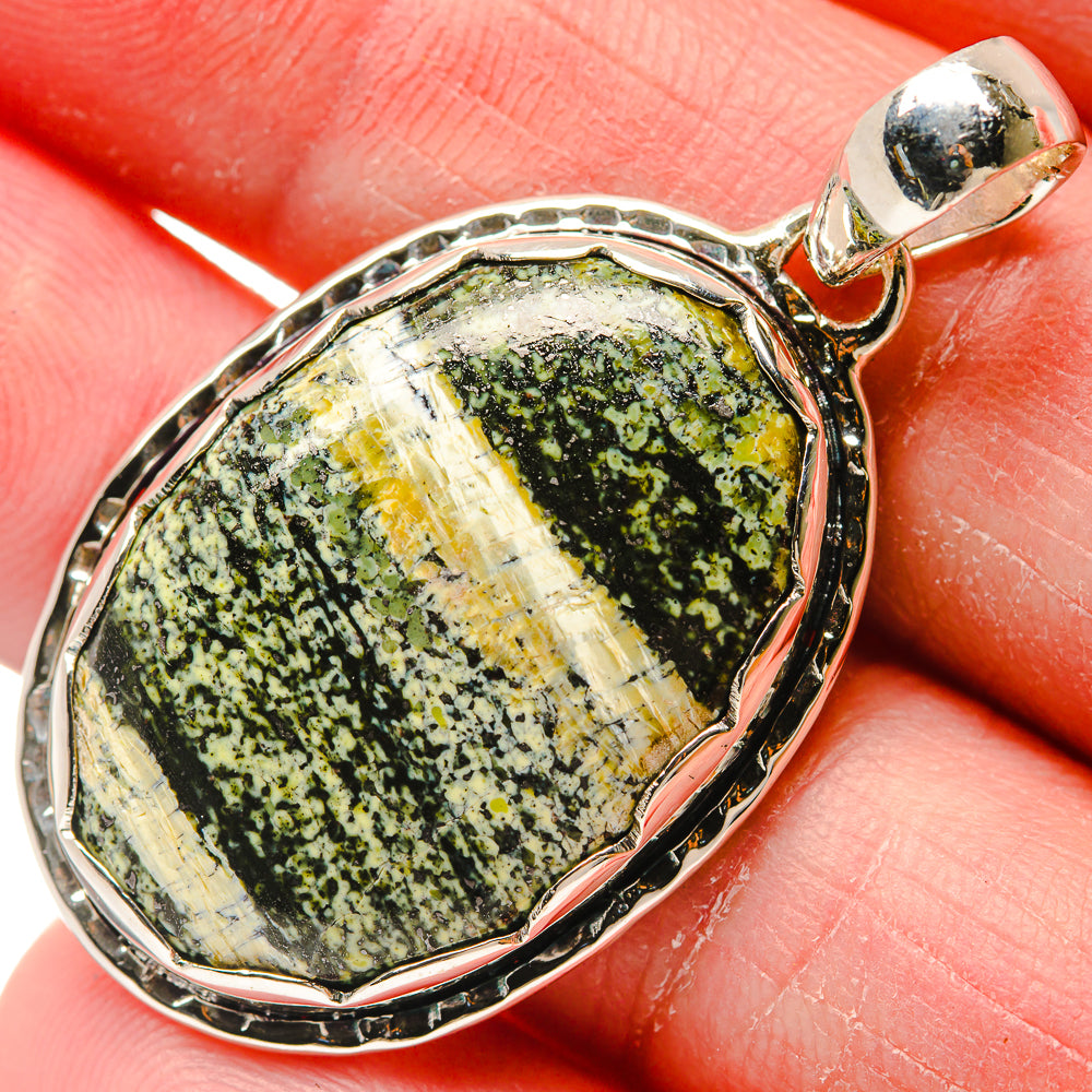 Oval ocean jasper pendant close-up, speckled green stone in 925 sterling silver bezel