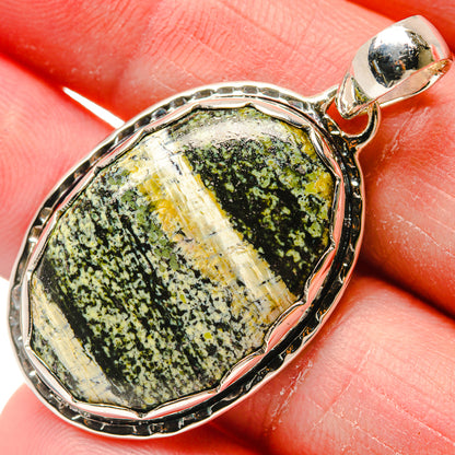 Oval ocean jasper pendant close-up, speckled green stone in 925 sterling silver bezel