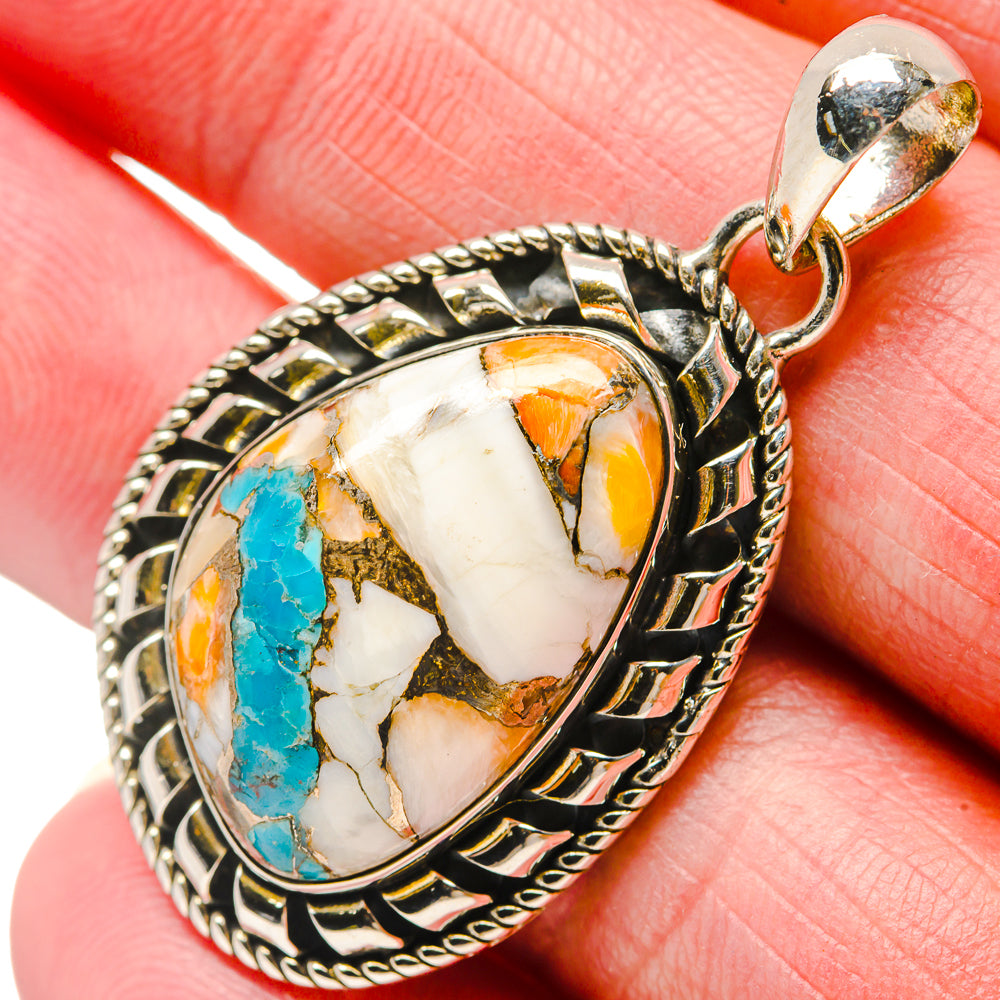 Oval turquoise, orange, and white stone pendant in ornate 925 sterling silver frame