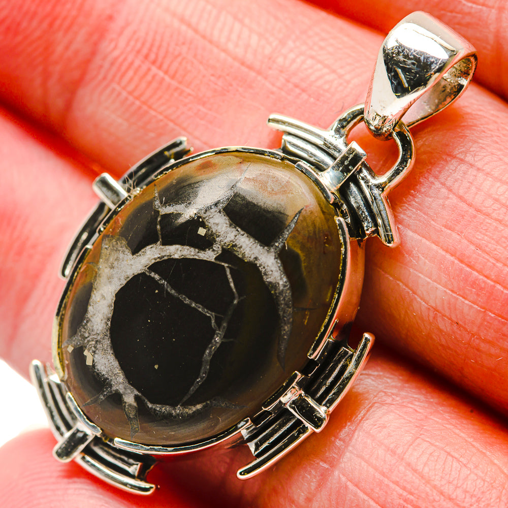 Round silver bezel pendant with black-and-gold septarian geode stone