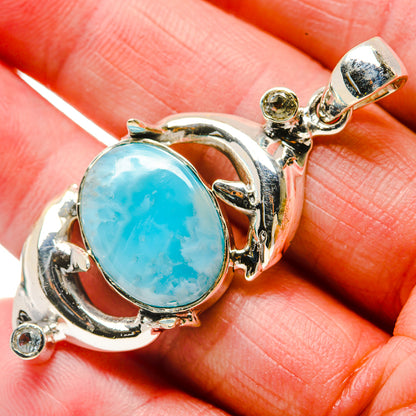 Close-up oval larimar pendant with polished 925 sterling silver bezel and tiny clear stones