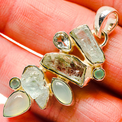 Aquamarine rough-stone pendant close-up with top bail and small round accents, 925 silver
