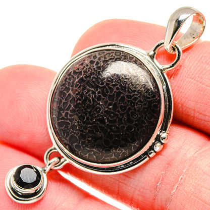 Round black onyx-look pendant with silver bezel and two dangling black stones