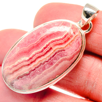 Rhodochrosite pendant with oval pink-and-white banded stone in silver bezel