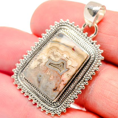 Sterling silver lace agate pendant close-up with rectangular stone and textured beaded edge