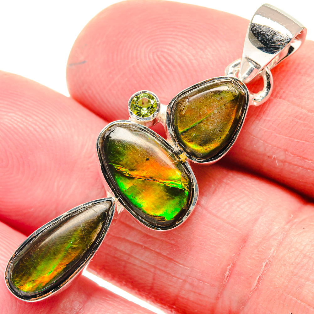 Sterling silver pendant with three iridescent green stones and small round green gemstone detail