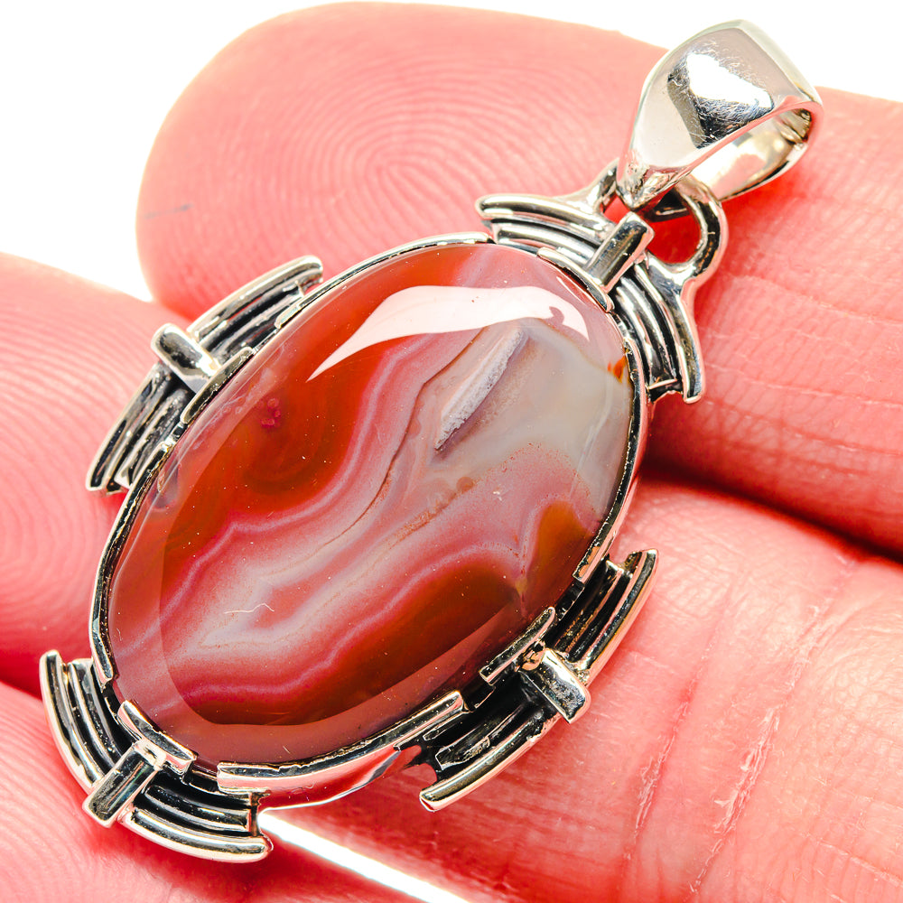 Oval red Botswana agate pendant with ornate 925 sterling silver setting and bail
