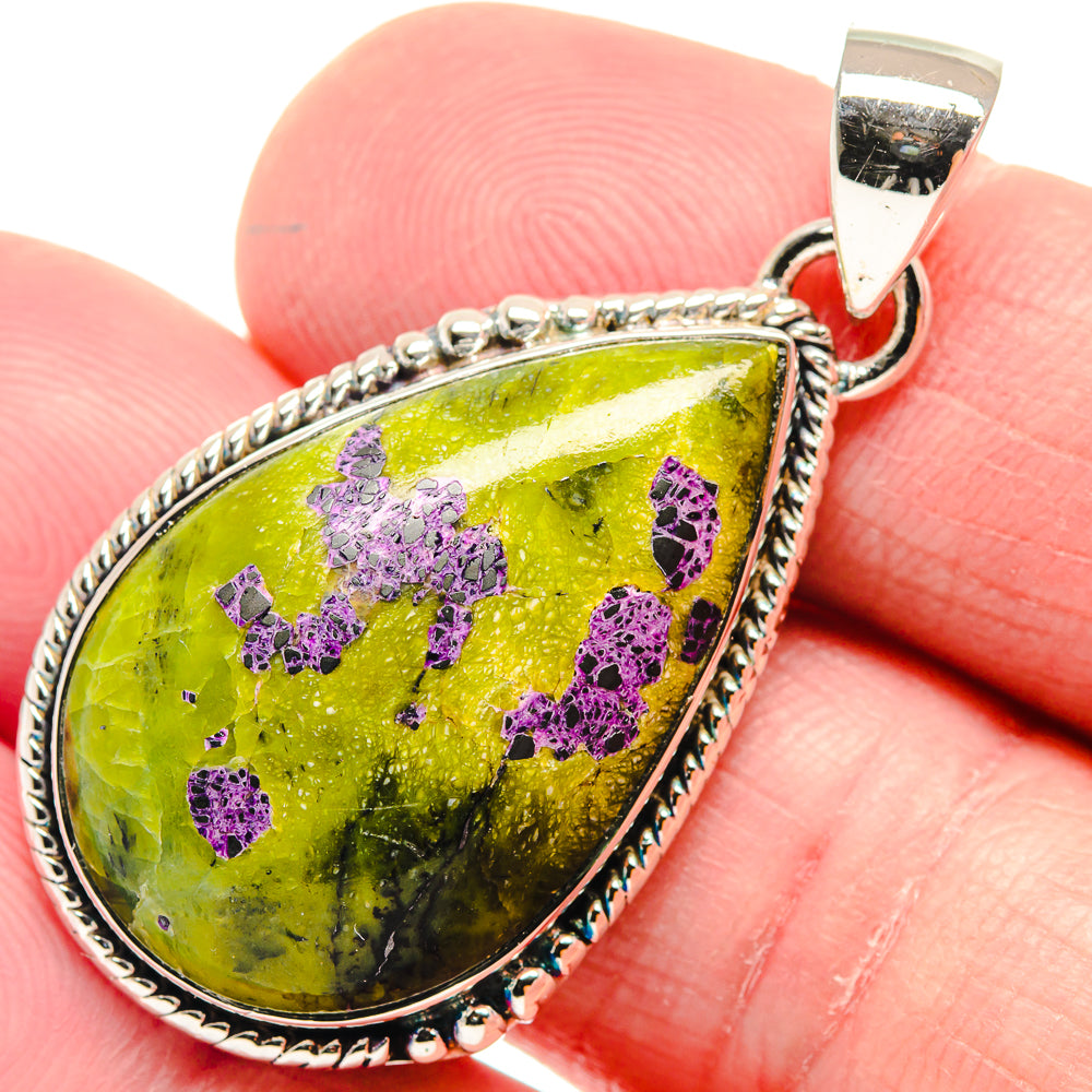 Sterling silver teardrop pendant with bright green and purple druzy stone, close-up