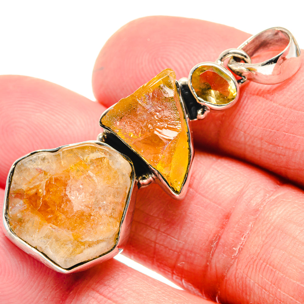 Rough citrine pendant detail, yellow-orange crystal in silver settings with round bail