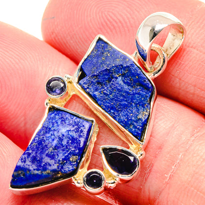 Rough blue lapis lazuli pendant in gold-tone bezel with dark round accents