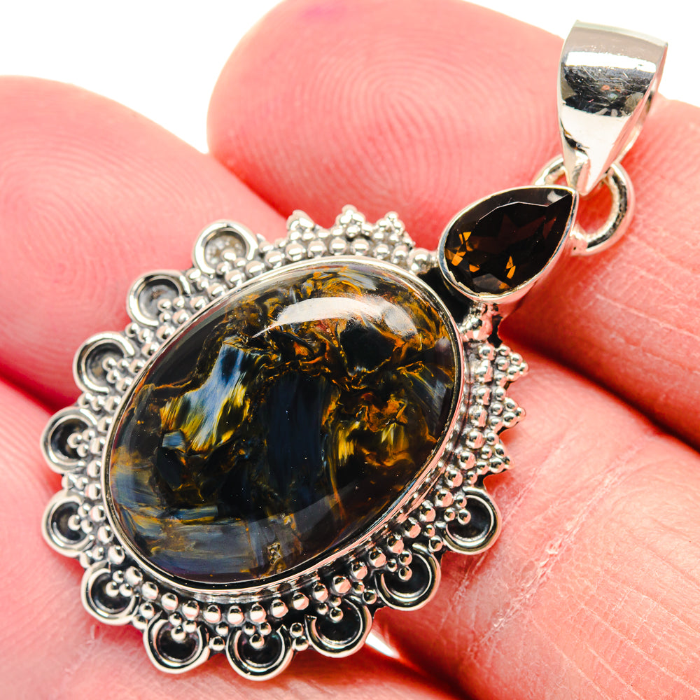 Oval smoky quartz pendant with halo of silver filigree and dark teardrop accent