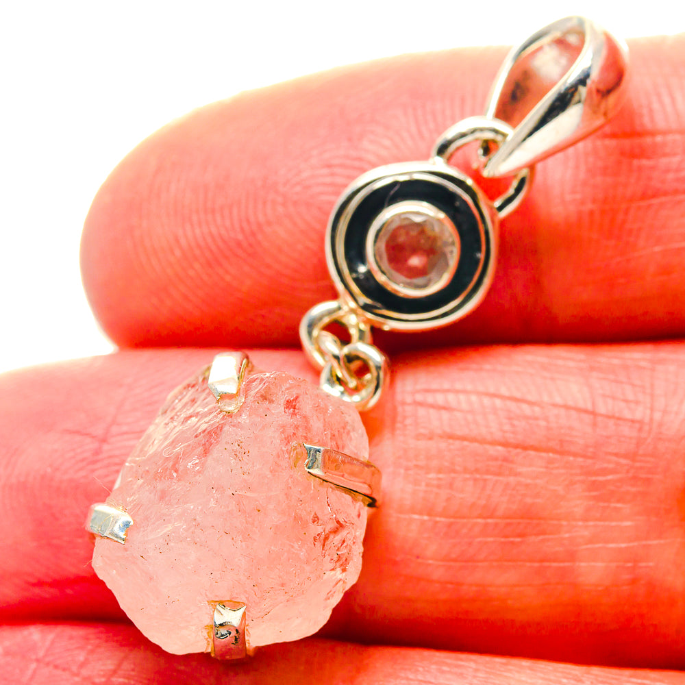 Rough pink rose quartz pendant with silver bail, circular bezel, and small round stone