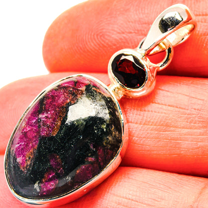 Oval eudialyte pendant in 925 sterling silver with garnet-red bezel on bail