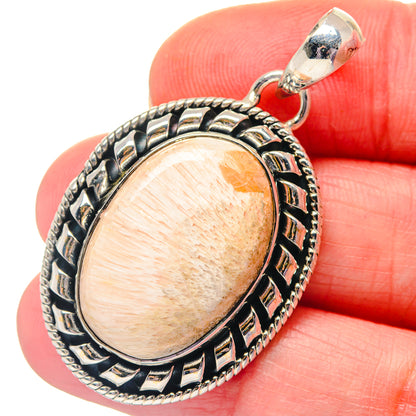 Oval scolecite pendant close-up, peach cabochon in ornate 925 sterling silver frame