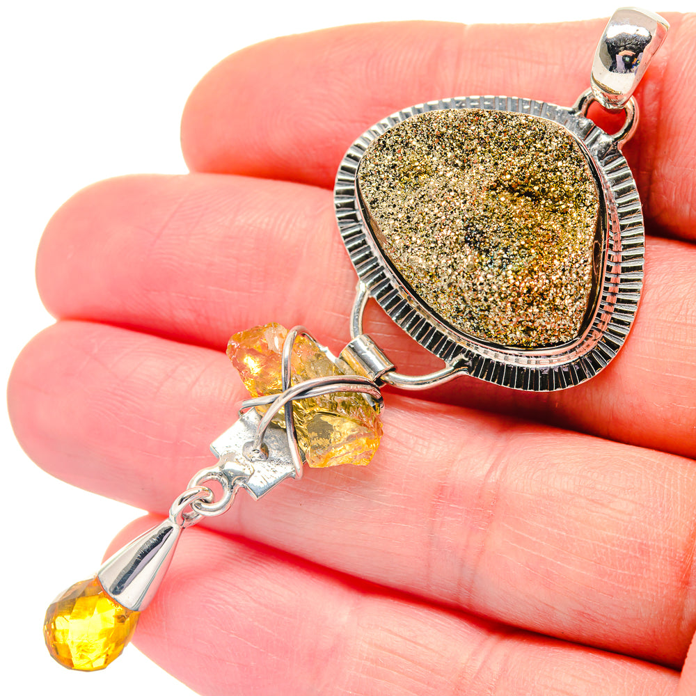 Oval druzy peacock ore pendant, silver bezel with textured border and two dangling citrine drops