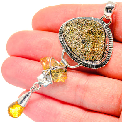 Oval druzy peacock ore pendant, silver bezel with textured border and two dangling citrine drops