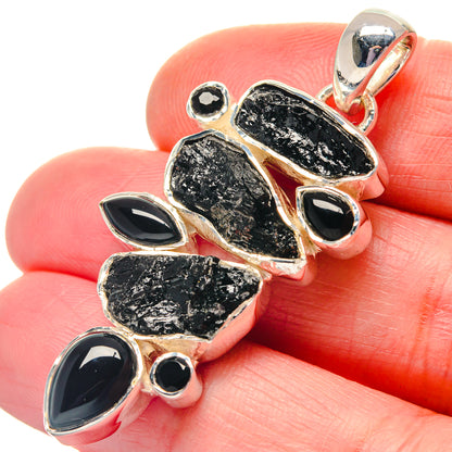 Rough black stone pendant with oval black onyx cabochons and 925 silver bail, close-up