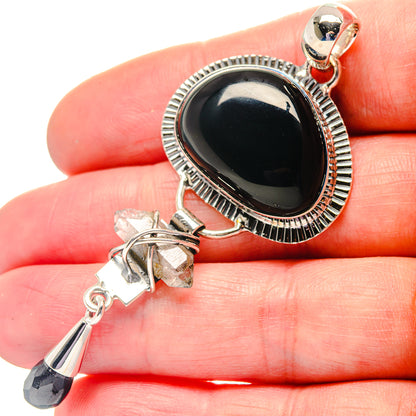 Sterling silver pendant with oval dark onyx, rough crystal charm, and black drop dangle