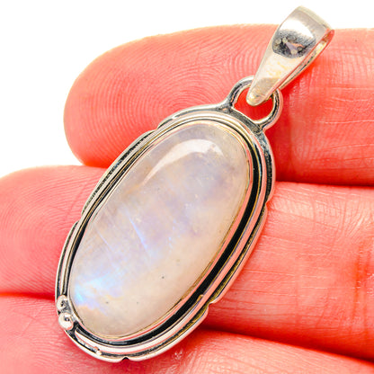 Oval rainbow moonstone pendant in oval sterling silver bezel with top bail
