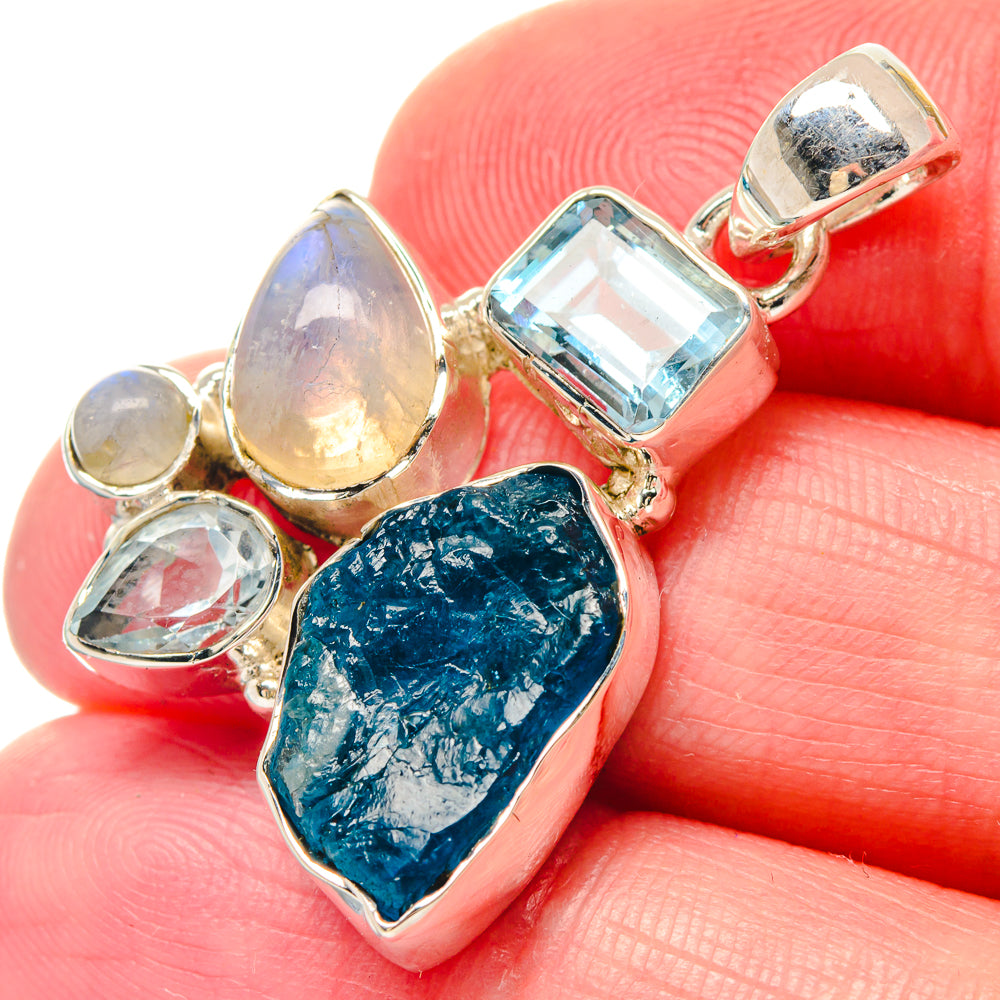 Sterling silver pendant close-up with rough blue teardrop and faceted light-blue stones