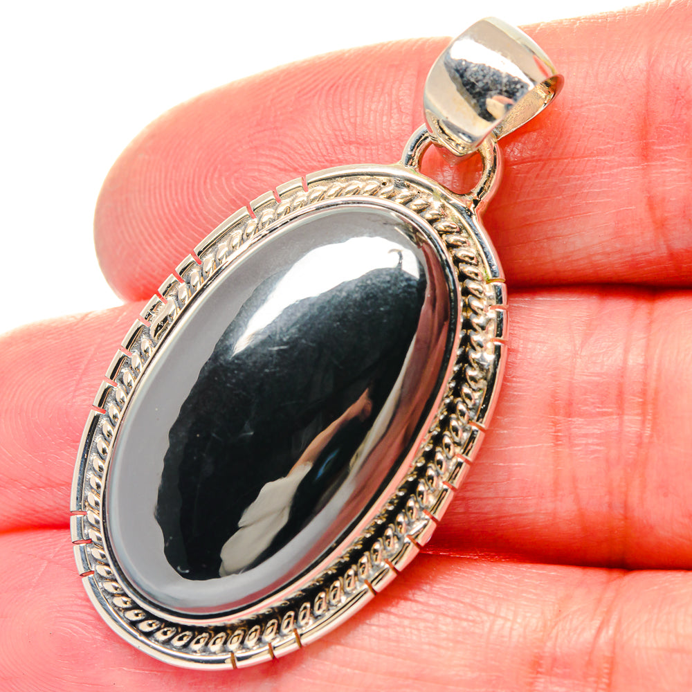 Silver hematite oval pendant with ornate bezel and bail, polished mirror face