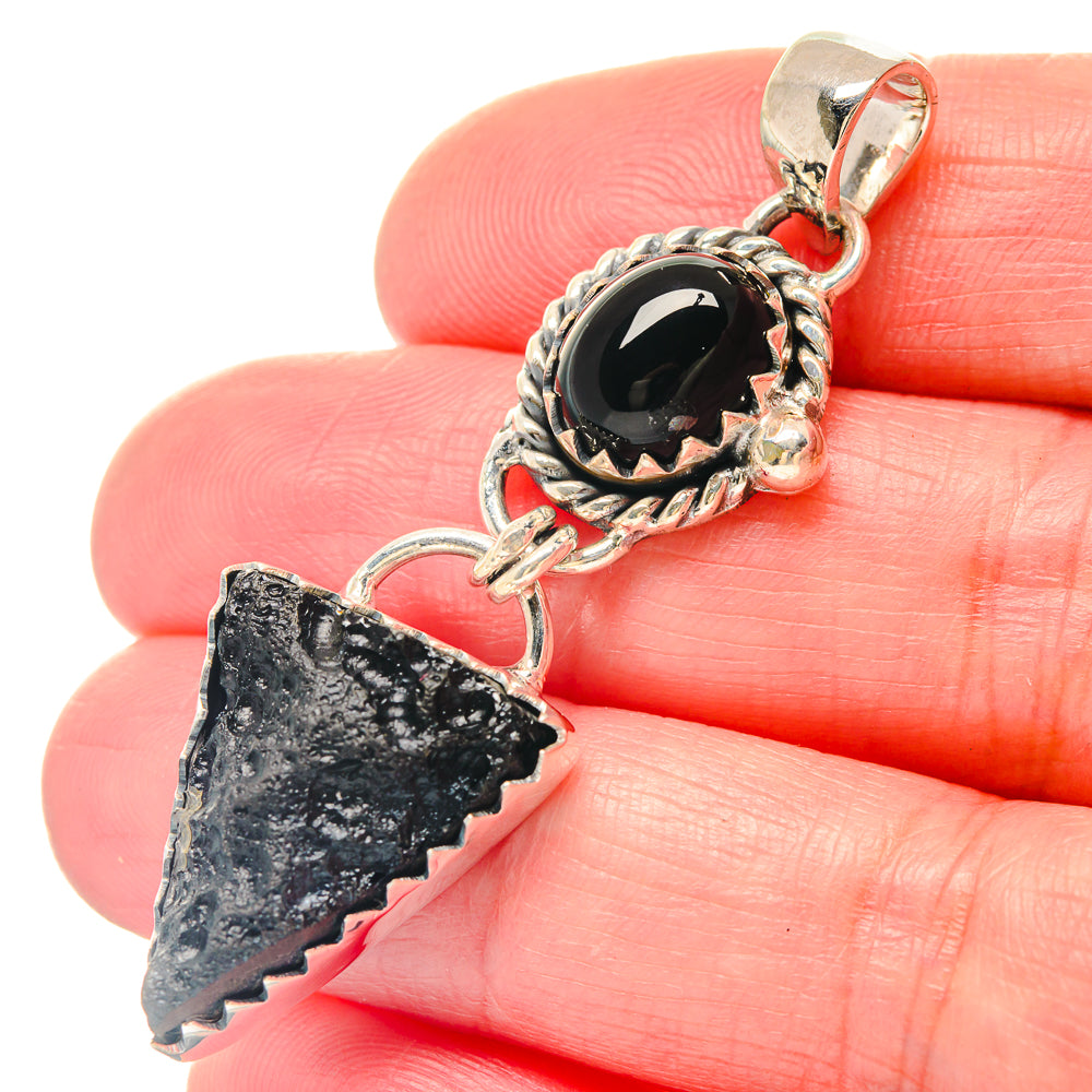Sterling silver pendant with black oval stone and jagged dark arrowhead