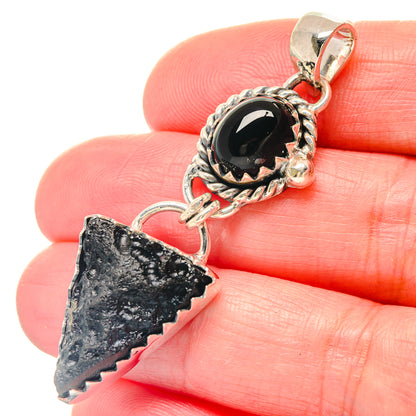Sterling silver pendant with black oval stone and jagged dark arrowhead