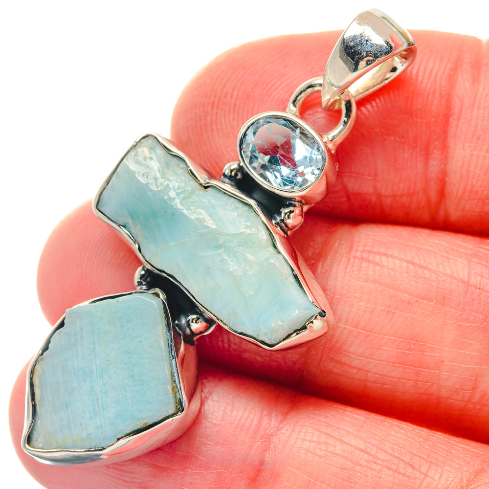 Sterling silver larimar and blue topaz pendant with three light-blue stone pieces