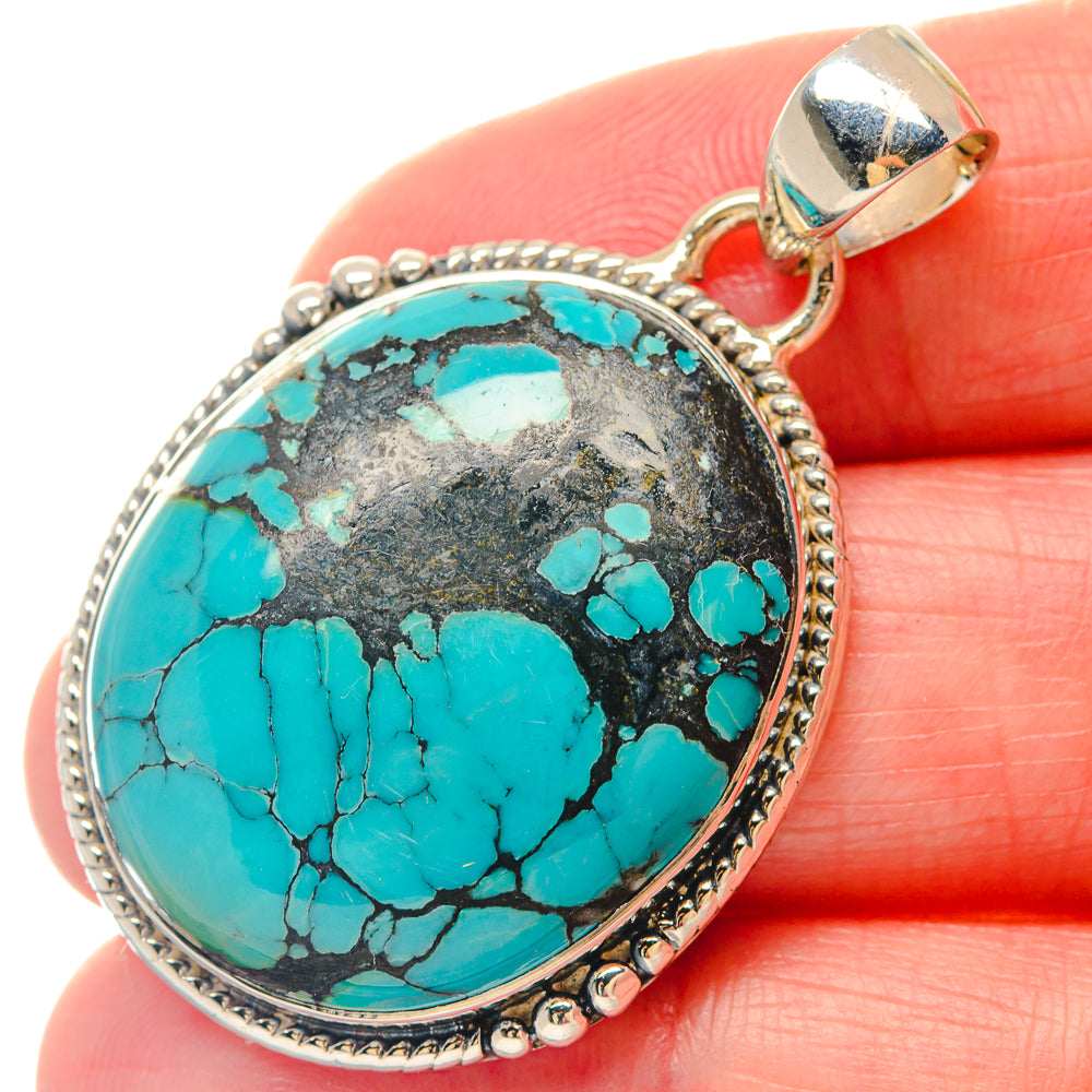 Turquoise cabochon oval pendant in sterling silver bezel with bail, detailed border