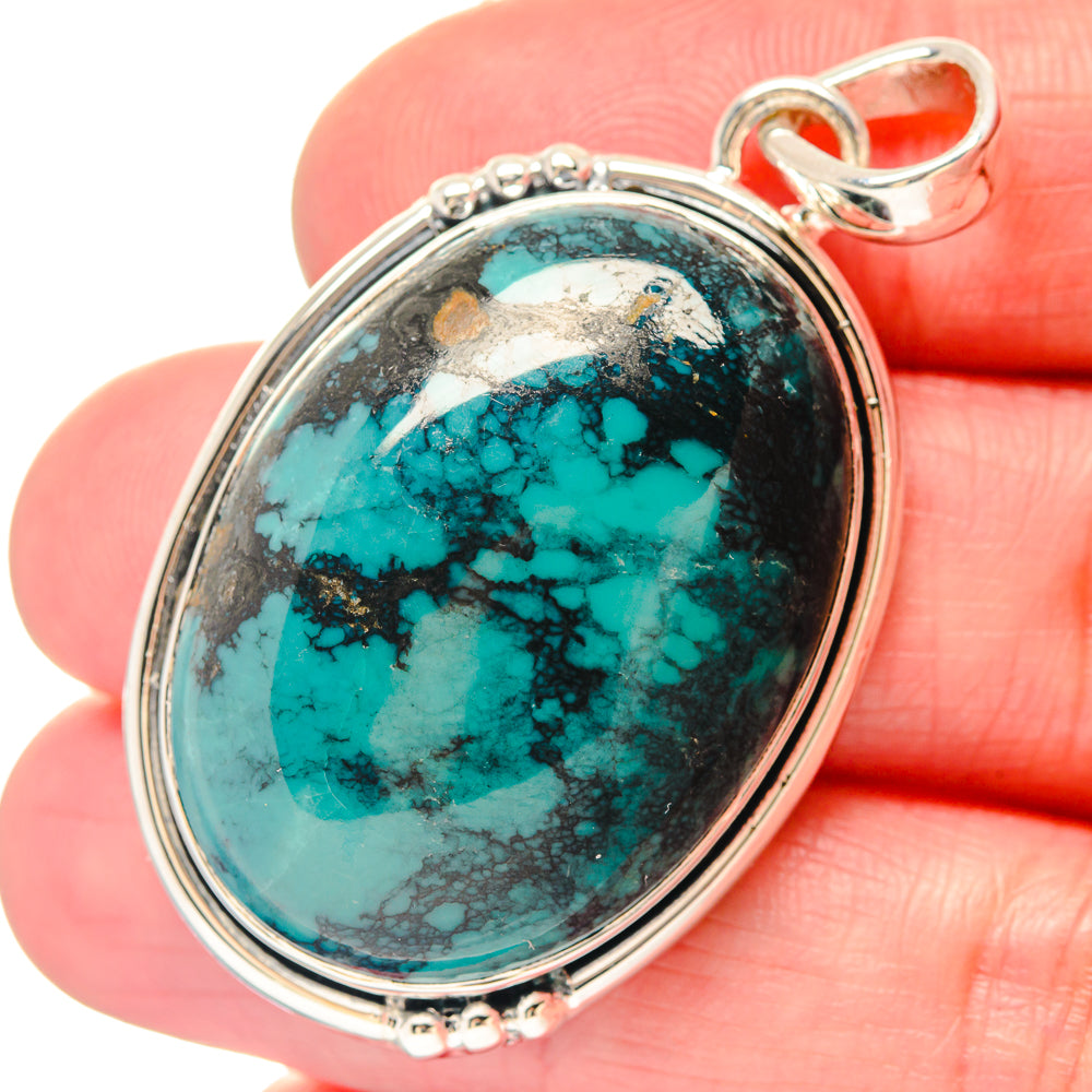 Oval turquoise cabochon pendant in 925 sterling silver bezel with loop bail