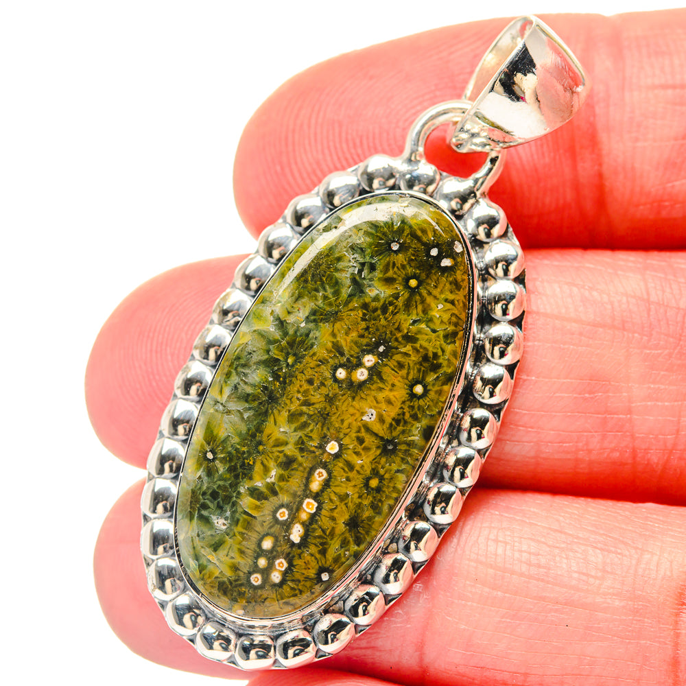Oval ocean jasper pendant with sterling silver bail and bead border