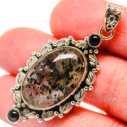 Close-up oval dendritic opal pendant with black onyx stones, ornate 925 silver setting