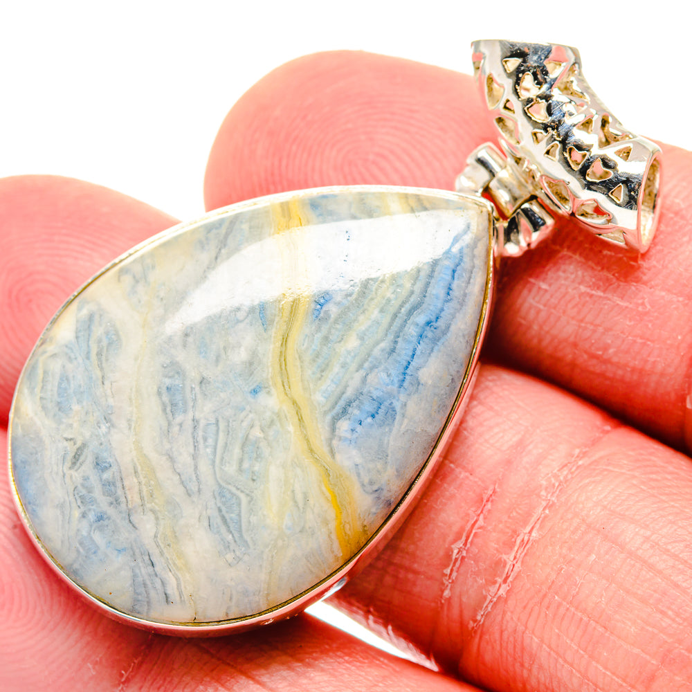 Teardrop blue scheelite pendant with yellow and blue veining, silver bezel and bail