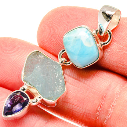 Sterling silver pendant with rough aquamarine-blue and green stones, plus purple teardrop