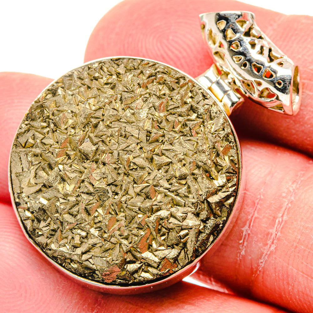 Rough pyrite pendant with silver bezel and textured disc, bail visible