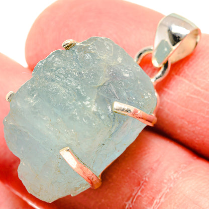 Rough aquamarine pendant detail: light blue stone with 925 silver prongs and bail