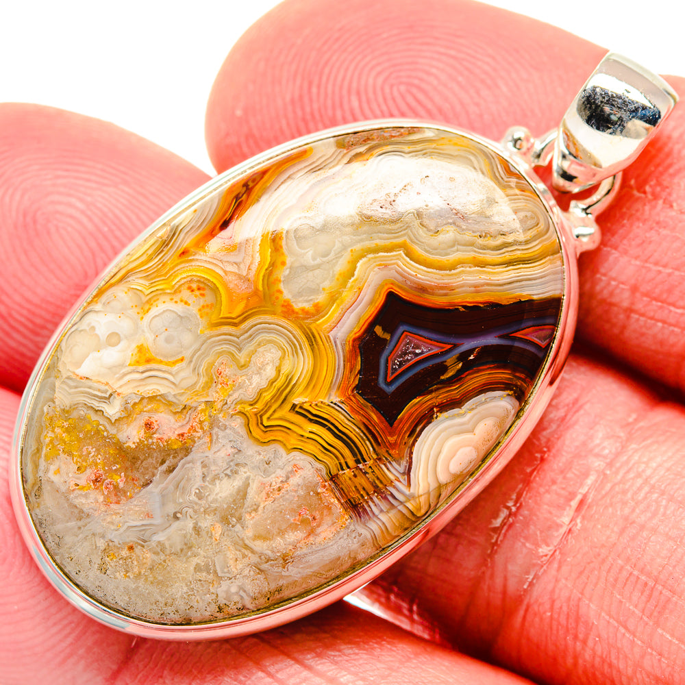 Oval agate pendant in 925 sterling silver, banded orange and cream with dark center