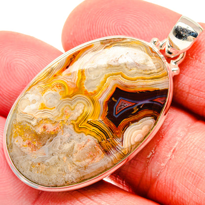 Oval agate pendant in 925 sterling silver, banded orange and cream with dark center