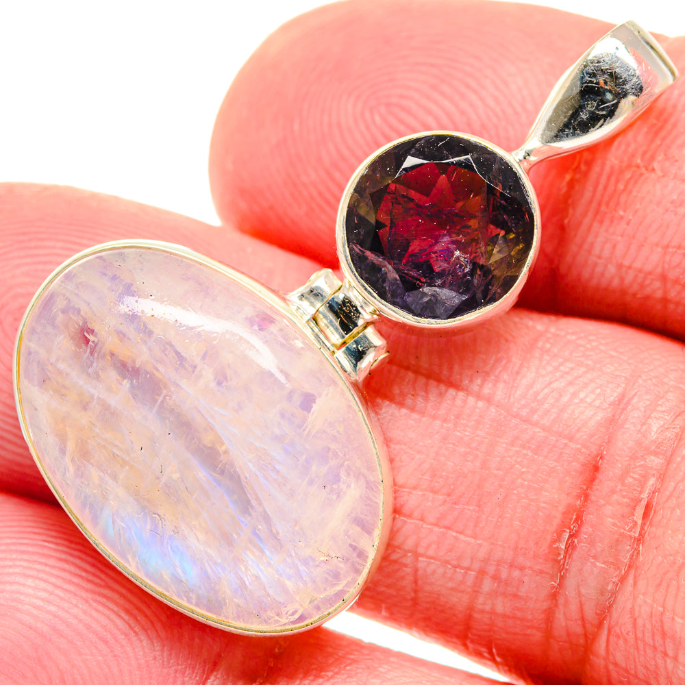 Sterling silver pendant with oval rainbow moonstone and dark red-purple gemstone top