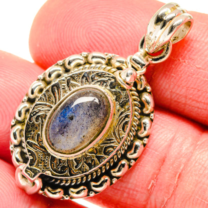 Close-up oval labradorite poison pendant with ornate 925 sterling silver bezel and bail