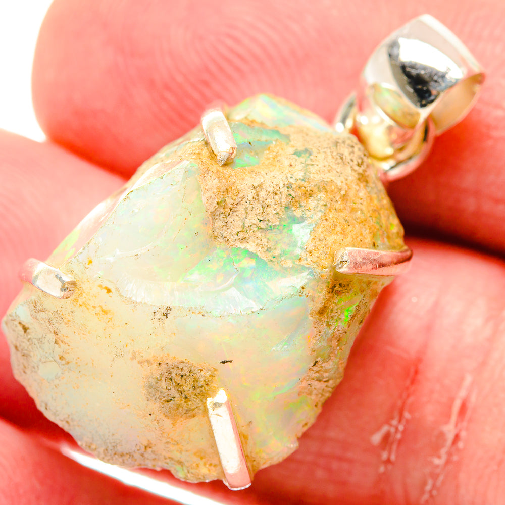 Rough opal pendant in sterling silver bezel with gold-toned accents and loop bail