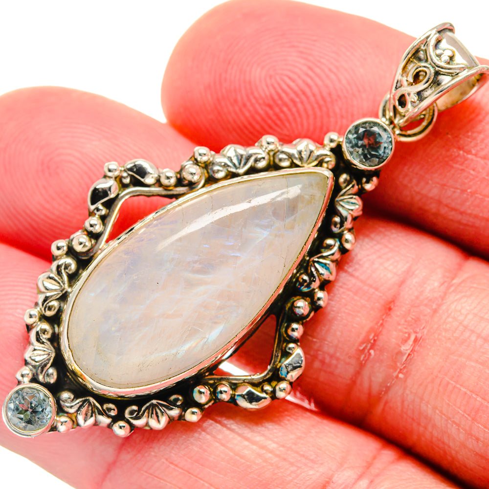 Sterling silver teardrop moonstone pendant with blue round gemstone accents