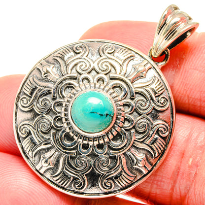 Silver-tone Tibetan turquoise pendant with ornate bezel and turquoise cabochon