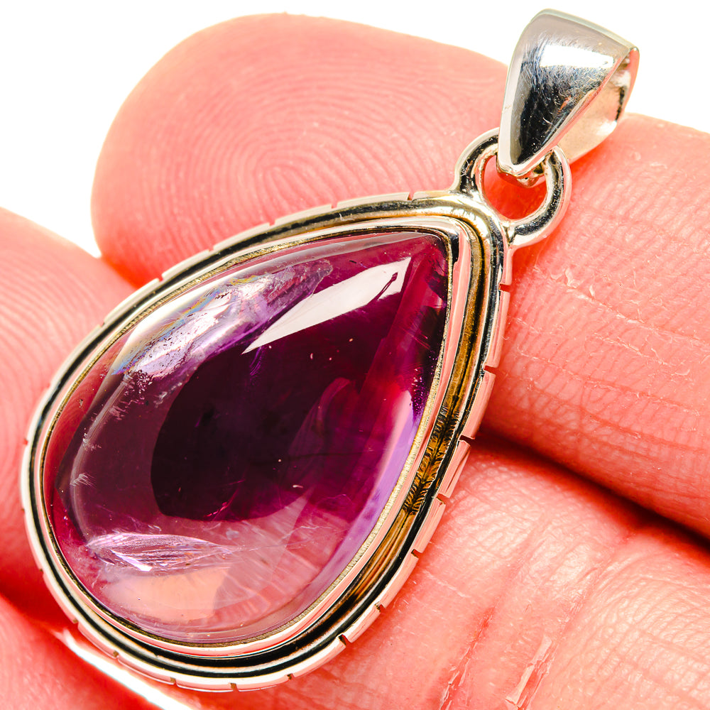 Teardrop amethyst pendant in sterling silver with red-toned inner border, close-up