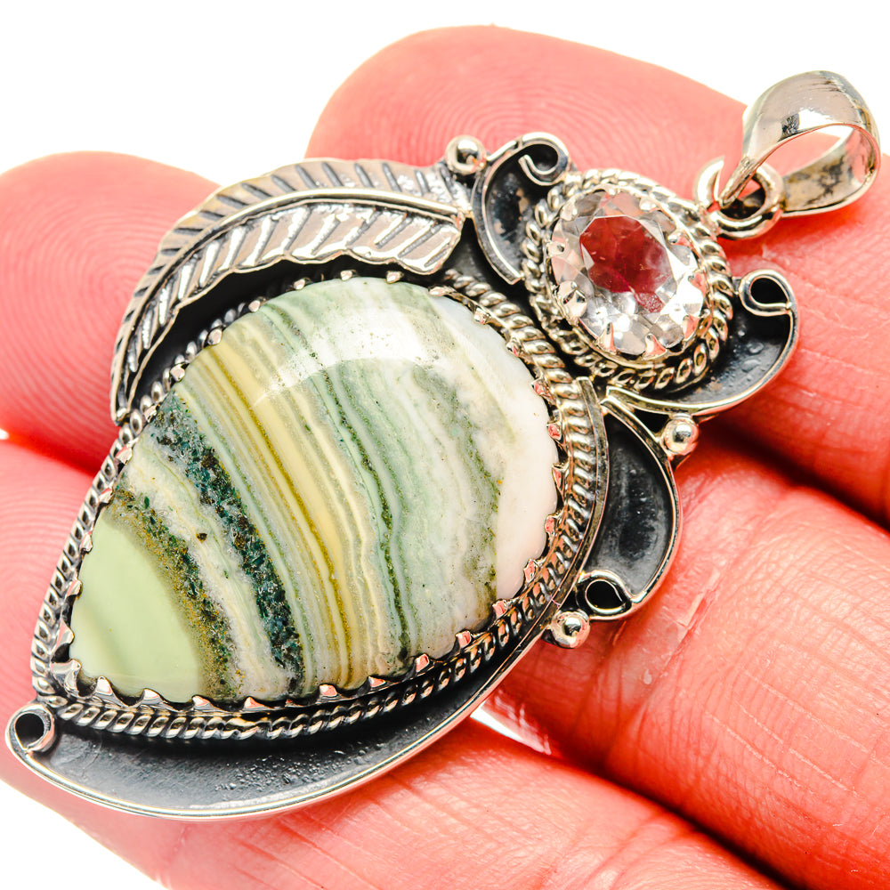 Sterling silver pendant with ocean jasper slice, red accent stone and ornate bezel setting