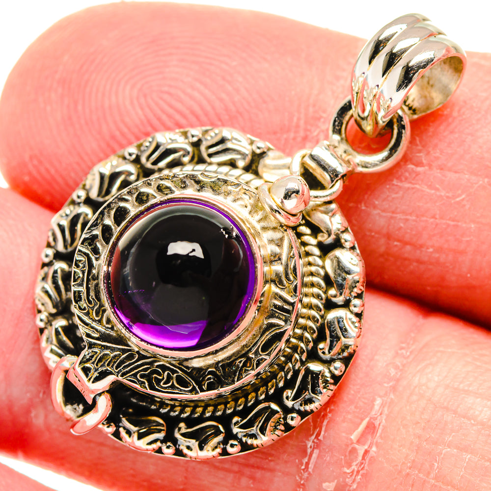 Poison Amethyst sterling silver pendant with round ornate frame and dark purple gemstone