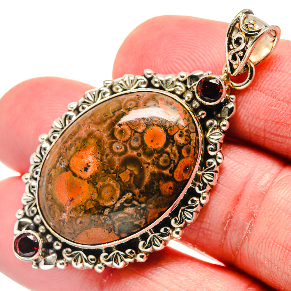 Oval poppy jasper cabochon pendant with ornate 925 sterling silver frame, garnet accents