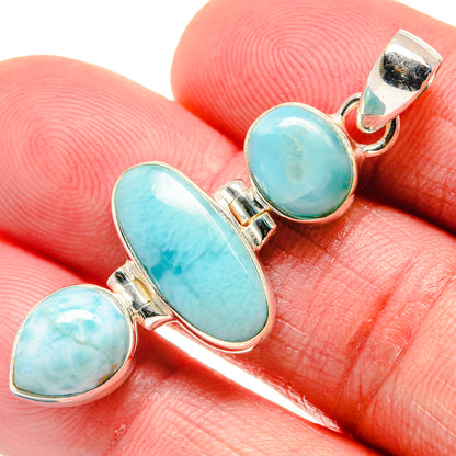 Larimar pendant close-up: three oval turquoise-blue cabochons with sterling silver frame